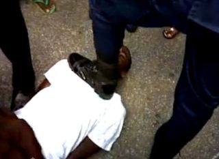 officers from the guyana police force stomps mans neck and kicks him to the head
